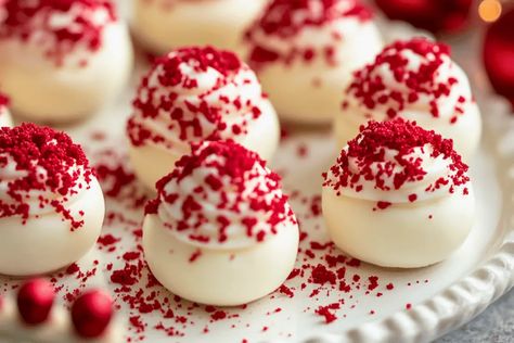 These No-Bake Red Velvet Cheesecake Bites are creamy, vibrant, and easy to make! A perfect treat for holidays, parties, and gifting. Red Velvet Cream Cheese Balls, Eggnog Cheesecake Bites, Mini Cheesecake Bites Christmas, Cheesecake Bites Christmas, Red Velvet Cheesecake Balls, Christmas Mini Desserts Bite Size, Cheesecake Balls No Bake, No Bake Cheesecake Balls, Red Food Ideas Party