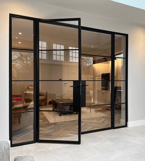 Affordable Elegance with Black Aluminium Crittall Style Doors: Elevate your home's interior and exterior with the timeless appeal of Crittall style doors. This blog post offers practical tips on how to incorporate these sleek, black aluminium doors into your space, ensuring luxury and style on a budget. Ideal for homeowners looking for a high-end look with affordability. Black Frame Door Exterior, Crittall Style Doors, Black Crital Doors, Large Crittal Doors, Black Metal Office Door, Black And Glass Doors Interior, Pantry Crittal Door, Black Paned Glass Wall, Glass Wall Black Frame