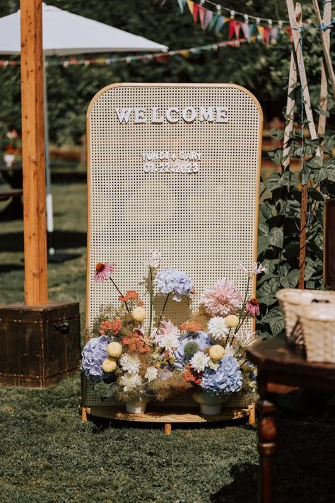 charming rattan wedding welcome sign with pastel primary color floral arrangements for a sunny outdoor ceremony Brides 2024, Bespoke Decor, Minimal Contemporary, Retreat Ideas, Garden Display, Colourful Wedding, Wedding Backdrop Design, Wedding Brides, Organic Wedding