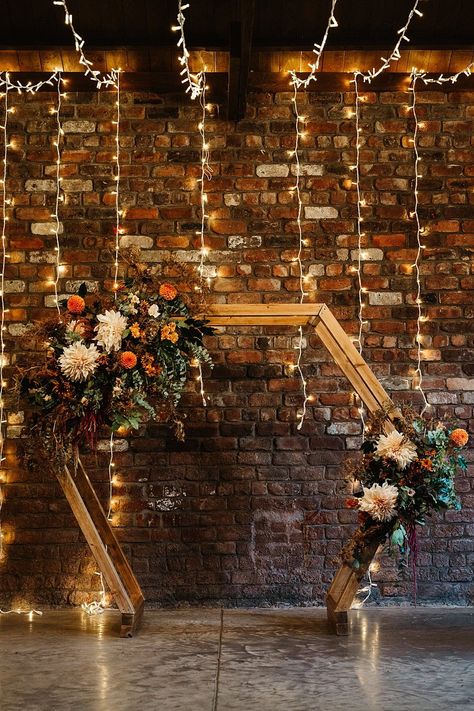 Wooden Hexagon Flower Arch Ceremony Engine Works Wedding Emma Lawson Photography #wedding #weddingarch Fall Wedding Arch Decorations, Hex Wedding Arch, Wooden Hexagon Wedding Arch, Hexagon Wedding Backdrop, Hexagon Flower Arch, Hexagon Wedding Arch Flowers, Fall Wedding Backdrops, Autumn Wedding Arch, Wedding Arch Hexagon