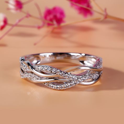 Bring the bling with this shimmering band. Expertly crafted in sterling silver, this clever style features gracefully intertwined ribbons to create a sparkling intertwined design. This unique band is a glittering gift of truest love.Carat Weight: 0.46 ctStone Size: 1 mmStone Type: Jeulia® StoneNumber of Stones: 46 Stone Color: Diamond WhiteStone Shape: RoundWeight: 4.57 gWidth: 5.64 mmHeight: 2.42 mmThickness: 2.86 mmMaterial: 925 SilverPlating Color: Silver Infinity Band Ring, Infinity Wedding Band, Twist Wedding Band, Crossover Diamond Ring, Half Eternity Band, Wedding Band Ring, Diamond Anniversary, Moissanite Wedding Bands, Engagement Bands