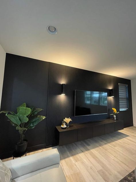 Tv With Paneling, Basement Faux Fireplace, Black Walls Light Wood Floor, Black Accent Wall Entertainment Center, 70” Tv Wall, Black Finished Basement, Slat Wall Living Room Ideas, Black Accent Wall Movie Room, Black Accent Wall With Fireplace And Tv