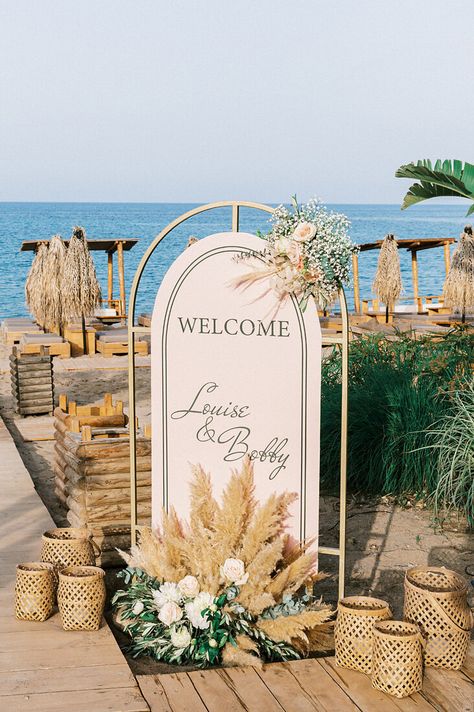 “Whimsical Folk” Wedding Style. Coastal ceremony at Tulum. Reception at Kalami Beach Bar Restaurant. Mediterranean Sea Views. Colors: White, Beige, Terracotta, Dusty Pink, Green. Destination Wedding Planned by Golden Apple Weddings, Rhodes Island. Bride and Groom Wedding Portraits. #destinationweddings #Greece #Rhodes #island #bohowedding #beachwedding #beachbar #weddingtheme #weddingdecor #weddingevent #weddingphotography #weddingplanning #welcomesign #rattanlanterns #flowersynthesis #pampas Mediterranean Beach Wedding, Wedding Welcome Sign Beach, Beach Wedding Welcome Sign, Pampas And Roses, Coastal Ceremony, Coastal Wedding Reception, Beach Garden Wedding, Beach Bar Restaurant, Gold Beach Wedding