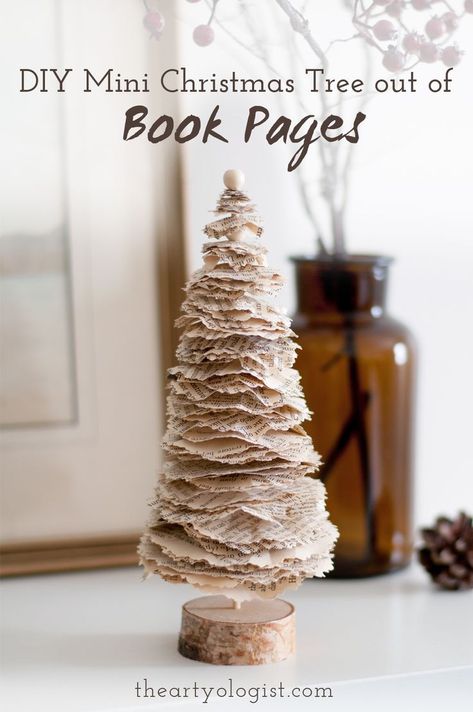 A little Christmas tree decoration made out of old book pages, sitting on a shelf with a vase of branches in the background Making A Tree, Paper Garlands, Book Christmas Tree, Old Book Crafts, Christmas Tree Crafts, 12 December, Holiday Crafts Christmas, Mini Christmas Tree, Christmas Ornament Crafts