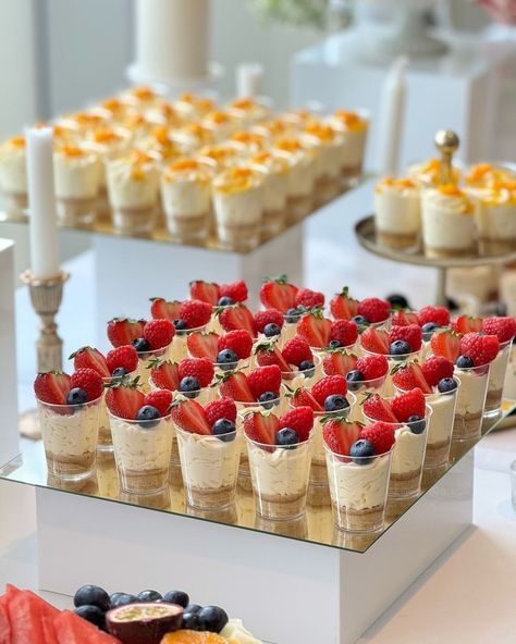 SheikhArts Desserts | Libby & Moore 🤍 Dessert table consisted of shot glass desserts, cakelettes, pavlova and fruit platters. Location: Hilton - Utilita Bowl... | Instagram Cheesecake Dessert Cup, Desert Catering Ideas, Desserts For Dessert Table Ideas, Grooms Dessert Table Ideas, Wedding Desserts Bar, Dessert Night Ideas, Simple Wedding Cocktail Hour Food, Dessert Table Desserts, Nikkah Dessert Table