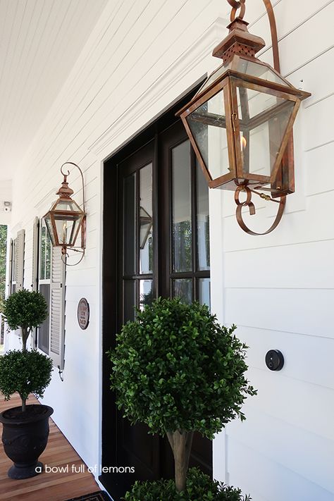 Our Southern Porch | A Bowl Full of Lemons Copper Front Porch Light, Front Porch Lights That Flicker, Gas Porch Lanterns, Exterior Gas Lanterns Front Entry, Colonial Outdoor Lighting, Solar Porch Lights Front Doors, Exterior Lanterns Front Door, Gold Outdoor Light Fixtures, Screened Porch Lighting