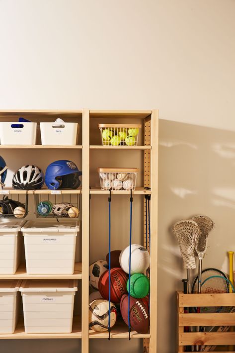 Here's a winning pregame strategy for corralling athletic gear. This system keeps them visible, so your home team can grab, go, and clean up (score!) with ease. #marthastewart #homeimprovement #hometips Ball Corral Diy, Ivar Garage Storage, Ikea Ivar Garage, Ikea Sports Equipment Storage, Ivar Garage, Ball Storage Ideas, Racket Storage, Sports Gear Storage, Sports Equipment Organization