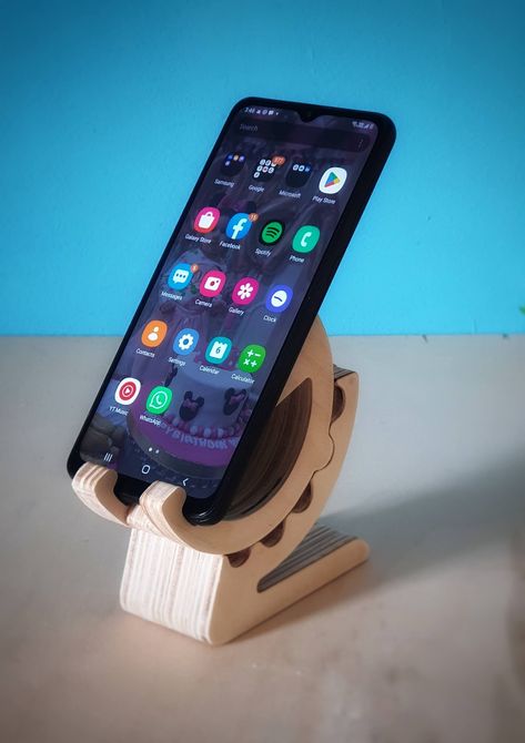 wooden mobile holder "Geared Style" made by CNC machine. Wooden Mobile holder fabricated using CNC Machine, pitch pine wood 11mm thick. The mobile holder is designed to hold the mobile in portrait or landscape view, and the angle steps (70, 48, 26, 4 degrees), the holder allows to maintain the mobile and connect the charger without any restrictions. Wood, Gear Stand, Pitch Pine, Wooden Mobile, Mobile Stand, Mobile Holder, Landscape View, Cnc Machine, Pine Wood