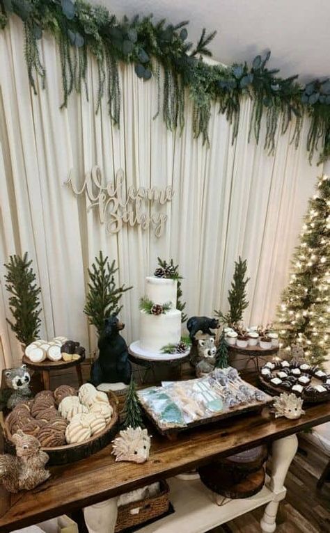 35+ Winter Wonderland Baby Shower Ideas You'll Swoon Over - One Sweet Nursery Winter Woodland Dessert Table, Dark Forest Baby Shower Ideas, Boy Baby Shower Woodland Theme, January Baby Boy Shower Ideas, Bridal Shower Forest Theme, Woodland Baby Shower Dessert Table, January Baby Shower Food Ideas, Christmas Baby Shower Table Decor, Pine Tree Baby Shower Theme