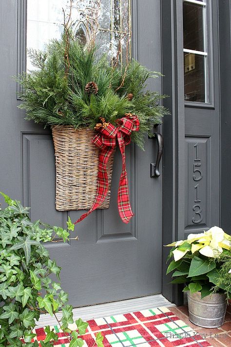 Holiday Basket Door Decoration - Sometimes the best approach to decorating a small porch is to go big with a basket full of beautiful winter greenery. #christmasdoorbasket #christmasdoordecoration #holidaydoordecoration #decoratingwithplaid #poinsettias Decorating A Small Porch, Holiday Door Decorations, Small Porch, Holiday Baskets, Winter Greenery, Christmas Planters, Christmas Porch Decor, Christmas Arrangements, Christmas Porch