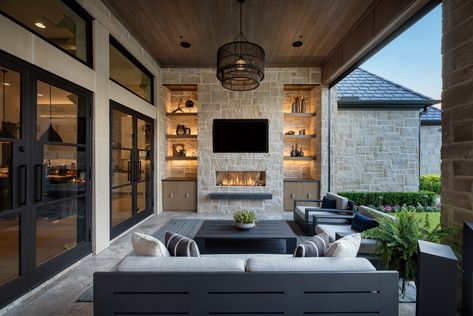 We're getting fired up with this indoor/outdoor space. With the help of motorized retractable screens, you can enjoy this space all year long. Fresh air, shade from the sun, climate control, protection from insects or a bit of privacy. Designed/Built by Tal Thevenot of Aquaterra Outdoors, in Carrollton, Texas. Photographed by Jimi Smith Photography www.jimismithphotography.com Outdoor Living Fireplace, Grill Outdoor Ideas Backyards, High Ceiling Outdoor Patio, Luxury Back Patio, Indoor Outdoor Living Patio, Built In Outdoor Fireplace, Indoor Outdoor Entertaining Area, Outdoor Great Room, Outdoor Room With Fireplace