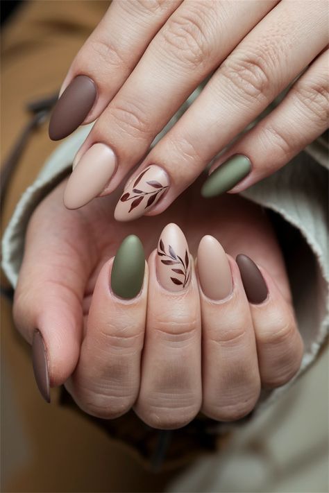 Embrace the cozy vibes of autumn with these simple yet chic fall nail ideas! Featuring warm earth tones and delicate leaf motifs, this nail design captures the essence of the season. The muted shades of burnt orange and deep burgundy complement any outfit, making it perfect for casual outings or festive gatherings. Get inspired to try this elegant look that combines simplicity with seasonal charm! Neutral Colored Nails With Design, Olive Green Nails Almond Shape, Nail With Leaves, Fall Nail Designs Sage Green, Olive Green And Cream Nails, Autumn Nails For Short Nails, Neutral Boho Nails, Simple Earth Tone Nails, Earthy Toned Nails