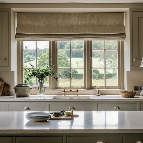 Don't neglect your kitchen windows - adding blinds can add some real personality and warmth. Linen Roman Blinds Kitchen, Cottage Window Blinds, Kitchen Window Roman Shade Over Sink, Roman Shades Large Windows, Roman Blinds In Kitchen, Roman Curtains Kitchen, Blinds In Kitchen Window, Farmhouse Kitchen Blinds, Kitchen Window Blinds Ideas