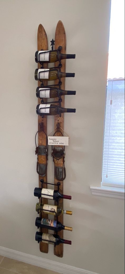 Old wooden skis turned into a wine rack. Ski Wine Rack, Old Ski Decor Ideas, Old Snow Skis Ideas, Ski Themed Living Room, Ski Living Room, Ski Display Ideas, Skis On The Wall, Repurpose Old Skis Ideas, Old Wooden Skis Ideas