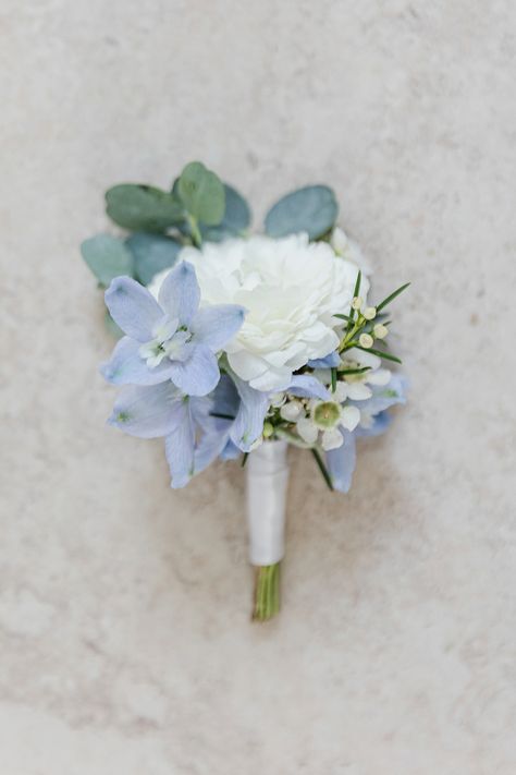 Green And Blue Boutonniere, Powder Blue Boutonniere, White Ranunculus Blue Delphinium Boutonniere, White And Blue Flower Boutonniere, Mountain Wedding Flowers Summer, Light Blue And White Corsage And Boutonniere, Dusty Blue And Sage Green Boutonniere, Blue White Corsage, Light Blue And White Boutonniere