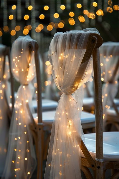 Transform your wedding into a fairytale with these stunning chair decorations. Tulle sashes and fairy lights add an ethereal touch to your reception. ✨🎀💡 Easy DIY setup for a night of wonder. #WeddingInspiration #FairyLights #DIYWedding #WeddingDecor #TulleDecorations #MagicalEvening #BridalStyle #WeddingChairDecor Let the romance sparkle! Fairy Light Decor Wedding, Wedding Chair Tulle, Diy Wedding Lights, Woodsy Wedding Reception Decor, Fairy Wedding Indoor, Evening Wedding Lighting, Rustic Lights Wedding, Evening Outside Wedding, Fairy Tail Themed Wedding