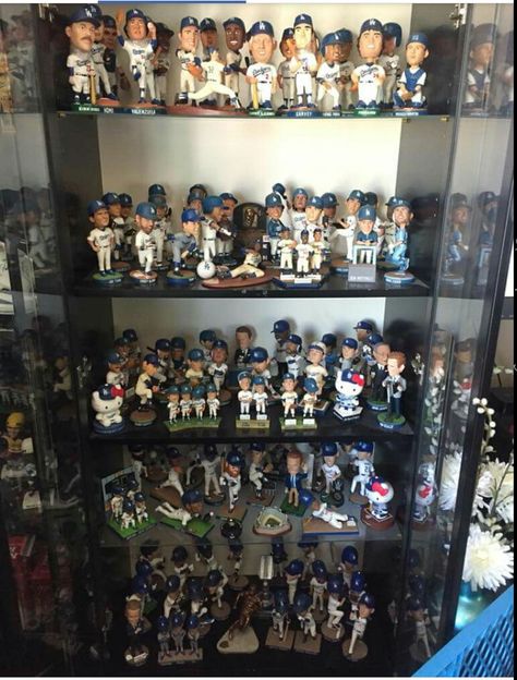 Dodger fan display of bobbleheads and figurines Bobble Head Display Ideas, Bobblehead Display, House Layout Design, Sports Display, Police Car Lights, Head Display, Doll Museum, Baseball Room, Bobble Heads