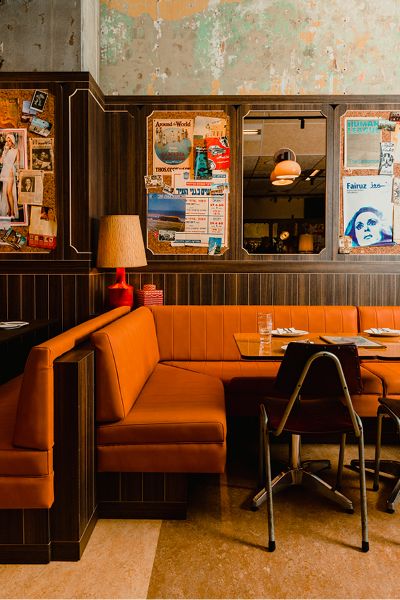 Midcentury Modern Restaurant Design, Restaurant Banquette Design, Mid Century Restaurant Design, Banquet Seating Restaurant, Mid Century Modern Bakery, 70s Restaurant Design, Modern Sports Bar Design, Colorful Restaurant Interior Design, Cozy Restaurant Aesthetic