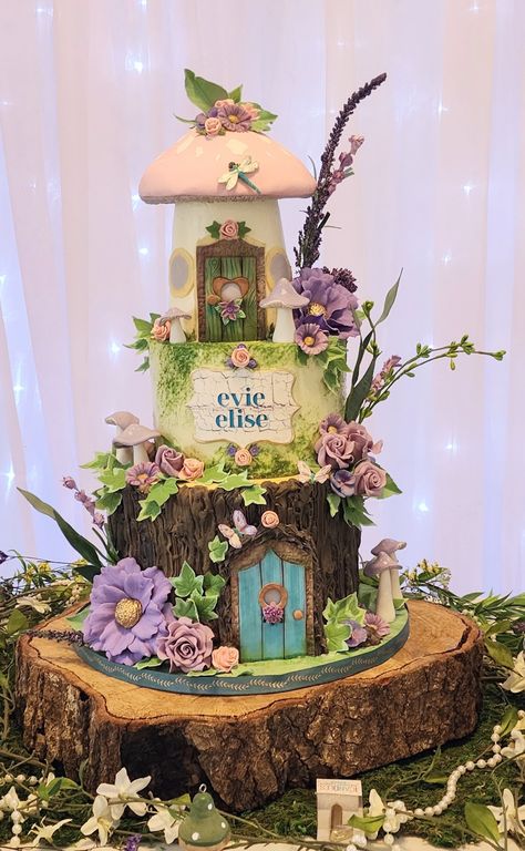 Buttercream iced cake with sugar flowers for evie, fairy door and toadstool cake top. Cute as can be Magical Fairy Cake, Fairy Forest Cake Ideas, Fairy Theme Wedding Cake, Fairy Tail Cake Ideas, Fairy Tale Birthday Cake, 2 Tier Fairy Cake, Fairy House Cake Ideas, Fairy Tale Cake Ideas, Fairy Log Cake