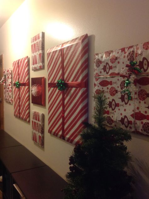 DIY Home Decorations for the holidays. Covered current wall pictures with wrapping paper and bows. Wall Decor Garland, Wrap Pictures On Wall For Christmas, Wrapping Paper Pictures Wall Art, Wrapping Paper Wall Christmas, Christmas Wrapping Paper Wall, Wrapping Paper Door Decoration, Teachers Lounge Christmas Decor, Wrapping Paper On Walls Christmas, Wrap Pictures On Wall Christmas