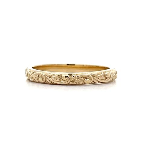 Designed in house by our expert jewelers – this custom modern wedding band is vintage inspired and beautiful. This new By Filigree engraved wedding band features a floral engraved pattern in 14 karat yellow gold. The swirling floral motif decorates the outer shank of the 2.79mm wide band. An unconventional wedding band that is truly unforgettable. Pair this wedding ring with a Yellow Gold Engagement Ring or wear in a right hand stack! Baroque inspired and modern made. Embossed Engagement Ring, Gold Filigree Engagement Ring, Etched Wedding Band, Antique Wedding Bands For Women, Engraved Wedding Bands For Women, Art Deco Gold Ring, Intricate Wedding Band, Vintage Inspired Engagement Ring, Engraved 14k Yellow Gold Ring With Filigree