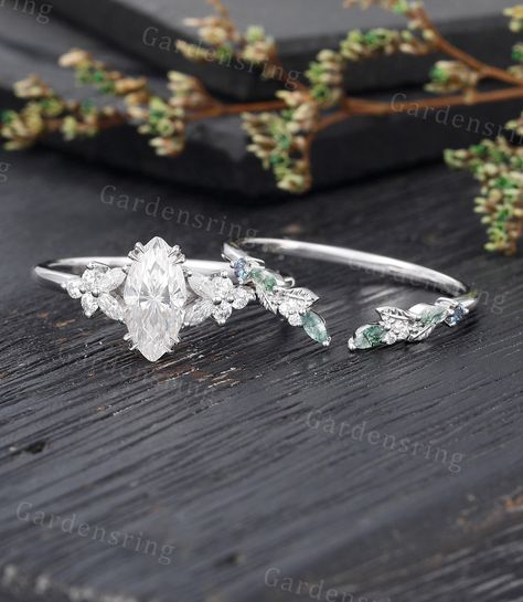 Marquise cut Moissanite Engagement ring set Vintage moss agate wedding band White gold Cluster shank Unique leaf Bridal set Anniversary gift ABOUT THIS RING Beautiful Moissanite engagement ring Set -------------------------------------------------------- 「Product Summary」 Engagement Ring * Center Stone: 5*10mm moissanite OR Simulated Diamonds  (Marquise cut) * Side Stones: 1.5*3mm Marquise cut Moissanite                           1.7mm Round Moissanite Or Side Stone: Simulated Diamond * Total Ca Wedding Band For Marquise Ring Silver, Marquise Leaf Ring, Uncut Diamond Rings, Marquise Flower Ring, Pretty Silver Engagement Rings, Marquise Engagement Rings Silver, Fairy Wedding Rings Silver, Whimsical Wedding Ring Set, Moissanite Engagement Ring Stack