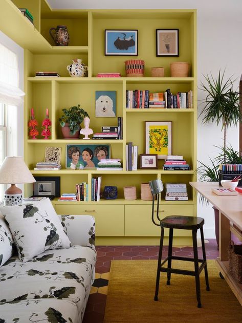 Display Corner Ideas, Funky Built In Shelves, Coloured Bookshelves, Painted Wall Shelves, Home Library Shelves, Bookshelf Eclectic, Sofa In Middle Of Living Room, Weird Corner In Living Room, Colored Bookshelf