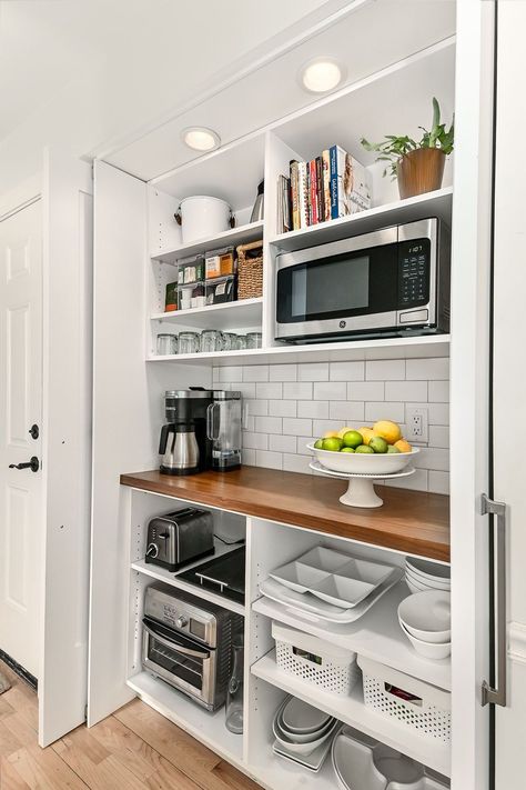 Coffee Bar & Appliance Closet – An old hallway closet is now a coffee bar with a butcherblock countertop. The microwave, toaster, and toaster oven remain hidden off the main kitchen counters. The retractable pocket doors can remain open while entertaining. Grab a cup of coffee! Appliance Closet, Closet Coffee Bar, Appliance Storage, Pantry Remodel, Countertop Appliances, Home Coffee Bar, Kitchen Pantry Design, Closet Kitchen, All White Kitchen