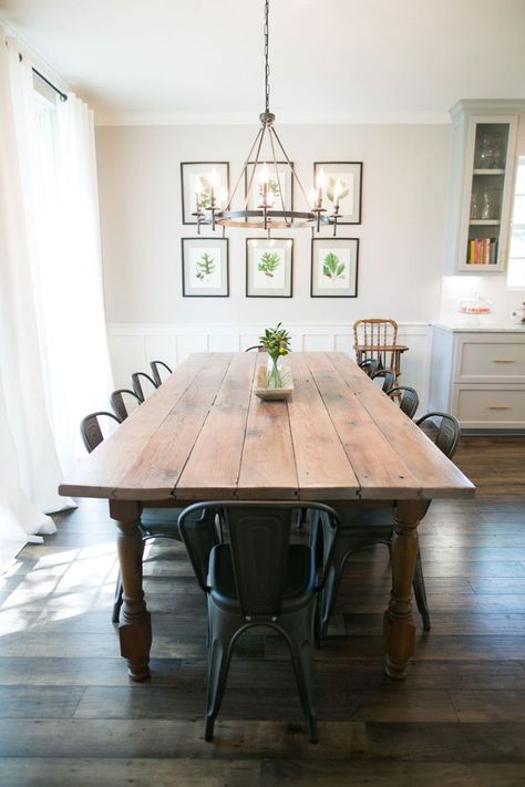 A former Fixer Upper client reveals what it’s really like to have Chip and Joanna Gaines renovate your home. Here, the dining room table is farmhouse beautiful! Wood Table With Wood Floors, Chandelier Over Farmhouse Table, Partial Shiplap Wall Dining Room, Farmhouse Dining Room Curtains Joanna Gaines, Wood Table With Metal Chairs, Wood Table Metal Chairs, Kitchen Table With Metal Chairs, Farmhouse Table Light Fixture, Dining Room Table Dark Floors