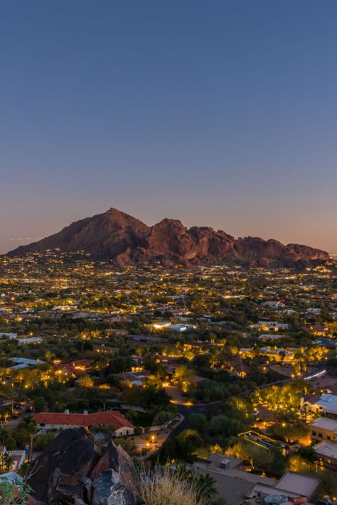 Camelback Mountain lit up with Scottsdale city lights for a magnificent view only available at this 2-acre lot in Paradise Valley, Arizona. City With Mountains, Arizona City At Night, Paradise Valley Arizona Houses, Phoenix City Aesthetic, Houses In Arizona, Phoenix Az Aesthetic, Arizona Neighborhood, Camelback Mountain Arizona, Arizona Wallpaper