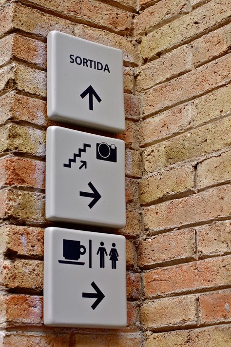 Wayfinding and Typographic Signs - caixa-forum-pictograms Brick Sign, Environmental Graphics Signage, Experiential Graphic Design, Door Signage, Wayfinding Signage Design, Signage Signs, Wayfinding Signs, Navigation Design, Retail Signage