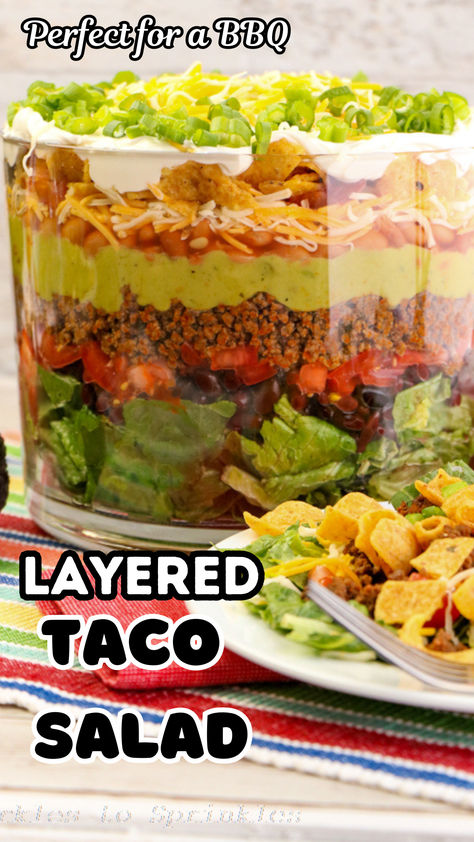 Layered Taco Salad Recipe: Perfect for summer gatherings, this easy and delicious salad combines romaine lettuce, beans, cheese, guacamole, and more! Fresh, flavorful, and fun to make, it's a crowd-pleaser that's sure to impress. Save this recipe for your next BBQ or potluck! Seven Layer Taco Salad Recipe, Layered Taco Salad Recipe, Layered Taco Salad, Layered Taco Salads, Layered Taco, Taco Salad Recipe, Taco Salads, Trifle Dish, Taco Salad Recipes