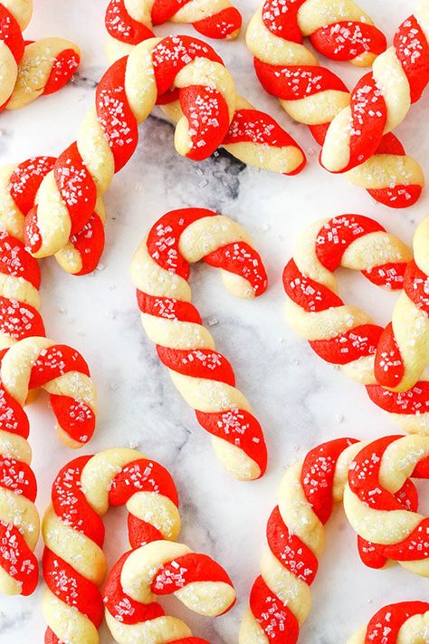 This Candy Cane Cookies recipe is a classic Christmas treat! It's made with a simple cookie dough that's flavored with peppermint, colored red and white, and twisted into a candy cane shape! #peppermint #candycanes #christmascookies Candy Cane Cookies Recipe, Candy Cane Cookie Recipe, Classic Christmas Treats, Italian Wedding Cookies, Candy Cane Cookies, Peppermint Cookies, Food Scale, Best Candy, Fun Cookies