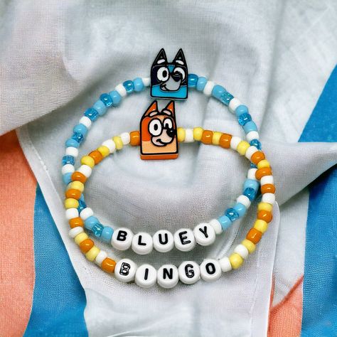 Custom Bluey and Bingo Charm Bracelet  ✨ Please be sure to choose your style of choice and your bracelet size before checking out ✨ ☆ 𝙲𝙰𝚁𝙴 ☆ To maintain the quality of your SimplyjustKnotted piece,  -avoid direct contact with perfumes, lotions, and other chemicals  -remove when bathing, showering, swimming and sleeping  ☆𝚀𝚄𝙴𝚂𝚃𝙸𝙾𝙽𝚂☆ If you have any questions, please feel free to send me a message. I want you to love your pieces as much as I love making them❤️ Have fun picking out your favorite piece! ☆𝚂𝙸𝚉𝙴𝚂☆ Standard (non-specified) size will be 6.5 inches  6"kids/tween 6.5" standard woman 7" 7.5" me 8" standard men ☆Children Sizes☆ 4-5 Yrs- 5.75 inches 6-7 Yrs- 6 inches 8-9 Yrs- 6.25 inches 10-11 Yrs-6.5 inches 12-14 Yrs 6.75 inches Bluey Mom, Custom Charm Bracelet, Bluey And Bingo, Custom Bracelet, Choose Your Style, Custom Charms, Bracelets Handmade Beaded, Custom Bracelets, Clay Beads