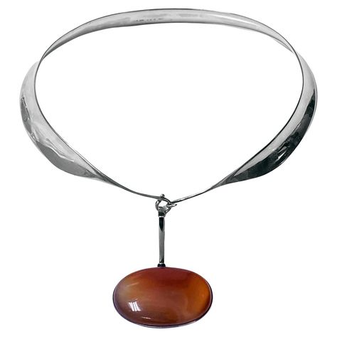 Vivianna Torun Bulow Hube for George Jensen, a rare Sterling Silver Necklace with reddish brown banded agate detachable pendant on collar, Denmark, C. 1975, stamped Georg Jensen in a dotted oval, Denmark, Torun, 133 pendant and 160 collar and 925S. Will fit up to 16 inch neck, pendant drop approximately 2.75 inches, width of agate 2 inches. Item Weight: 123 grams. Ref: The Jewellery Box Jens Ingvordsen P.275. Vivianna Torun Bülow-Hube know as Torun, was born 1927 in Malmo, Sweden. Torun was the Red Agate Necklace, George Jensen, Neck Pendant, Detachable Pendant, Billie Holiday, Malmo, Dope Jewelry, Banded Agate, Georg Jensen