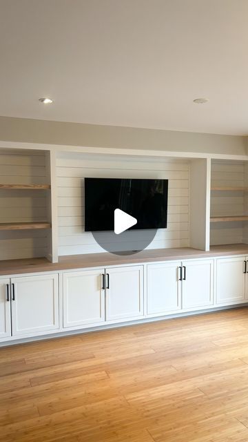 Suits & Sawdust | Custom Woodworking on Instagram: "Living Room Goals 🔥   This built-in entertainment wall made such good use of our client's living room space! It frames their TV beautifully while adding so much additional storage in the wall-to-wall lower cabinets. The white paint brightens the room while adding stained elements like the solid 15 ft countertop and upper shelves in a natural tone, warms the space up providing an extra homey feel 🤩  If you've debated booking a built-in, this is your sign! DM us ❤️ . . . . . . . . . . .  #shiplapwall #shiplapwalls #shiplapfireplace #livingroomstyle #livingroomgoals #livingroommakeover #accentwall #fyp #pov #livingroomideas #beforeandafter #feature wall #hometransformation #goals #storage #storagesolutions #customcabinetry #customwoodworki Built In Decor Ideas, Long Wall Of Lower Cabinets, Built In Cabinets With Bookshelves, Build In Shelf Living Room, Tv Room Cabinets Built Ins, Small Built In Tv Cabinet, Living Room Designs Built In Shelves, Rec Room Tv Wall, Built In Tv Wall Unit With Drawers