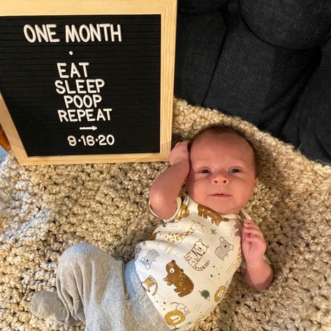 One month baby photo. Photo board says Eat, Sleep, Poop, Repeat. Infant laying on blanket next to sign. First Month Pictures Ideas, Newborn One Month Quotes, One Month Old Milestones Photo Ideas, One Month Old Photoshoot At Home, 1st Month Photoshoot Ideas At Home, One Month Milestones Baby Photos, Baby Boy Monthly Milestone Ideas, Boy 1 Month Photo Ideas, 1 Month Picture Ideas