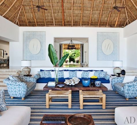 At a Mexican beach house by Martyn Lawrence Bullard, the living room sofa, with seat and back cushions of Chameleon fabric by Perennials, is flanked by custom-made chairs upholstered in Kaba Kaba linen by Bullard. Niches in the rear wall display Bali-inspired stenciling by artist Kelly Holden. Beach House Interior Living Room, Mexican Beach House Decor, Lake House Decor Living Room, Mexican Beach House, Mexican Beach, Beach House Interior Design, Dream Beach Houses, Mexican Home, Mexican Decor