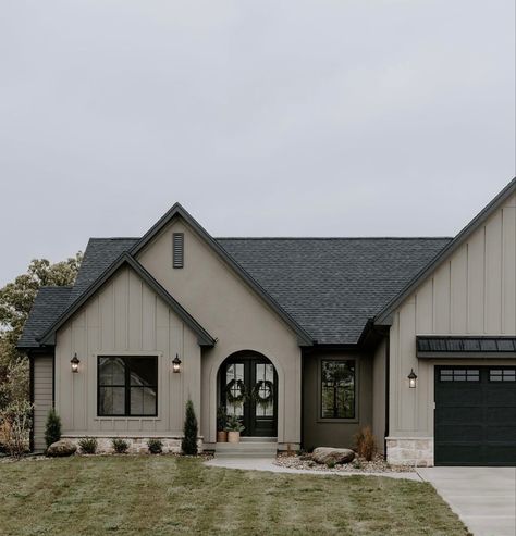 Black And Gold House Exterior, Tan House Gray Roof, Black Painted Stone Exterior, Aloof Gray Sherwin Williams Exterior, Modern Organic Exterior Design, Stucco With Board And Batten Exterior, Dark Colored Farmhouse Exterior, Stucco Board And Batten Exterior, Grey And Black House Exterior Modern