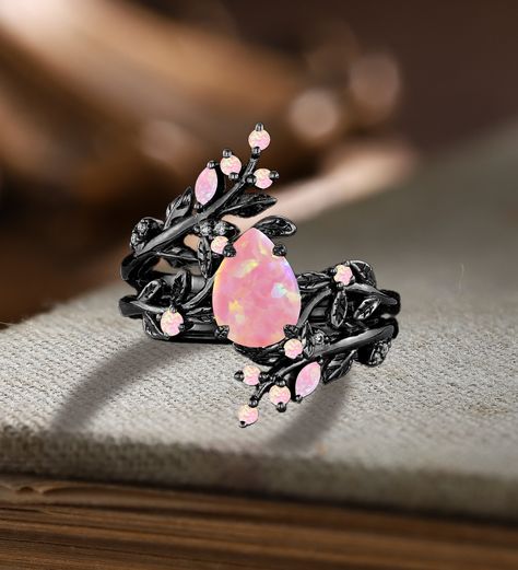 Unique Pear Pink Fire Opal Engagement ring Set Gothic Art deco Black Gold Cluster Vine Leaf Wedding Band Vintage Stacking Bridal Promise Set Applicable scene: anniversary, birthday party, wedding, engagement, gift ■ Handmade, high-quality item! ■ Material: S925 Sliver SOLID 14K/18K BLACK GOLD (can be made in white/rose/yellow gold) Engagement ring ■ Center stone: Pink Opal ■ Size/Weight: 6*8mm pear ■ Side stones: Pink Opal ■ Total weight: 0.042 ct (High Quality) ■ Cut - VG ■ Color: G-H ■ Clarity Unique Purple Engagement Rings, Black And Pink Wedding Rings, Unique Opal Engagement Rings, Ethereal Wedding Rings, Engagement Ring Not Diamond, Black Band Engagement Ring, Engagement Rings Fairy, Goth Wedding Rings, Flashy Engagement Rings