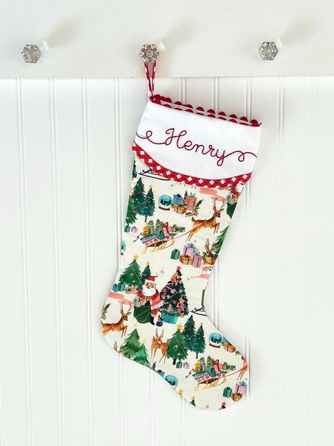 Our beautifully quilted Christmas stockings measure 20" diagonally from bottom of loop to tippy toe. Order with or without a matching red gingham bow. Our signature ric rac trim, custom hand embroidered name, red gingham trim and quilting make this a timeless addition to your Christmas decor. Fully lined with batting and piecing on both sides. You'll love the added surprise of how our cuff overlaps in the back. :: LEAD-TIME :: Please see shipping tab for current lead-time on Christmas stockings. Traditional Stockings Christmas, Christmas Stockings To Sew, Hand Sewn Stocking, Needle Point Stocking, Needlepoint Stockings Christmas, Quilted Christmas Stockings Ideas, Embroidered Stockings Christmas, Quilted Stockings Christmas, Christmas Shelves