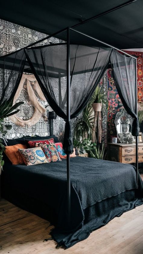 A captivating photo of a black boho-style bedroom, featuring a canopy bed with a sheer black canopy, adorned with a variety of colorful and eclectic cushions. The walls are adorned with a mix of intricate black and white wallpaper and colorful bohemian tapestries. The room also features a vintage-style wooden dresser, a decorative mirror, and an array of plants adding life and freshness to the space., photo