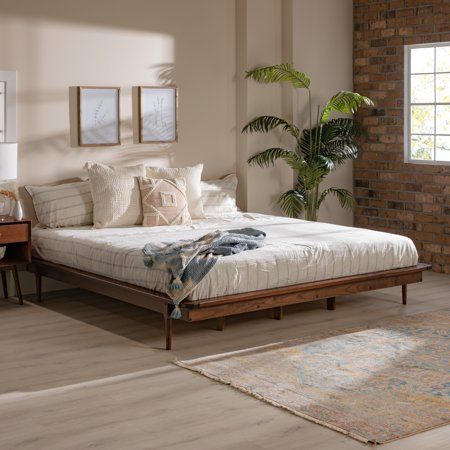 Accentuate your natural style with the Manor Park Mid Century Modern Wood Platform King Bed. This frame provides a perfect mix of style and function with the attractive tapered legs and wood support slats. The solid wood build offers a long-lasting piece to enjoy in your bedroom or guest room. Place it in a retro, modern, or boho style home for an elevated look. You can feel good about this purchase, as the wood is harvested responsibly from renewable forests. Pair with your favorite king headbo Philly Apartment, Platform King Bed, Dark Wood Bedroom Furniture, Boho Bedrooms, Mid Century Bed, Wood Platform Bed Frame, Modern Bed Frame, Mid Century Modern Wood, Wood Bedroom Furniture