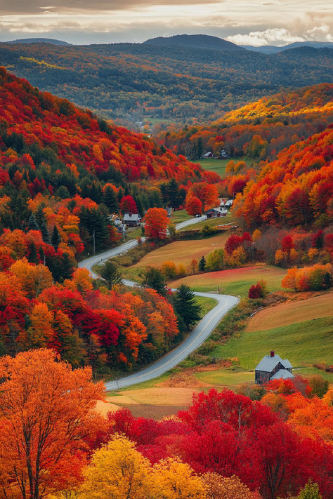 A scenic view of a winding road through a valley in New England, surrounded by vibrant fall foliage, one of the stops on the best fall foliage tours. Quaint houses dot the landscape, with rolling hills and forests in the background, creating a picturesque autumn scene. Fall In New England Aesthetic, Autumn In America, Fall In The Northeast, Connecticut Fall Foliage, Fall Towns To Visit, Fall Foliage New England, Halloween New England, Autumn In New England, East Coast Fall Aesthetic