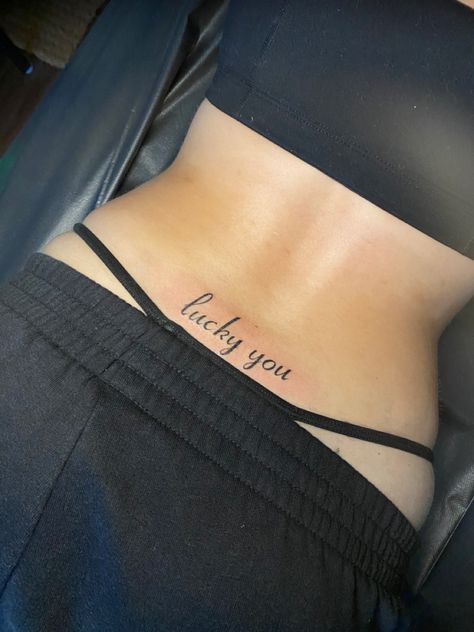 Lucky You Tramp Stamp Tattoo, Lucky You Back Tattoo, Unforgettable Tramp Stamp Tattoo, Trampstamp Tattoo Aesthetic Words, Deftones Tramp Stamp, Tramp Stamp With Words, Cute Simple Tramp Stamps, Tattoo Ideas Deftones, Trap Stamps Tattoo