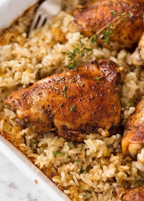 Close up of Baked Chicken and Rice in a white baking dish fresh out of the oven Hero Recipes, Baked Chicken And Rice, Australia Recipes, Arabisk Mad, African Foods, Carribean Food, Rice Recipes For Dinner, Paprika Chicken, Rice Dinner