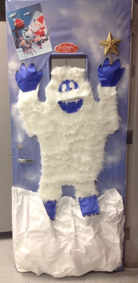 Abominable snowman classroom door at school. Too cute! Frosty The Snowman Door Contest, Frosty The Snowman Classroom Door, Yeti Door Decoration, Abominable Snowman Door Decoration, Yeti Christmas Door, Yeti Bulletin Board Ideas, Yeti Door Decorations For School, Rudolph Door Decorating Ideas, Gingerbread Doors