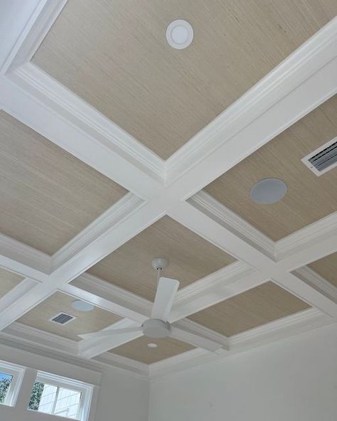 Nest Interiors & Boutique on Instagram: "Don't forget about your ceilings! Ceiling treatments don't get fingerprints from sticky hands, beat up from luggage banging into them, and the list goes on... beams, wood details, venetian plaster, wallpaper, or even just an accent color of paint can add so much character for a fraction of the cost of doing the rest of the room. Pictured here is a painted wood coffered ceiling with straw colored grasscloth wallpaper inset." Coffered Ceiling Great Room, Family Room Coffered Ceiling, Grass Cloth Ceiling Bedroom, Textured Wallpaper On Ceiling, Coffered Ceiling Wallpaper, Woodwork On Ceiling, Grasscloth Wallpaper On Ceiling, Modern Coffered Ceiling Design, Coffered Ceiling With Wallpaper