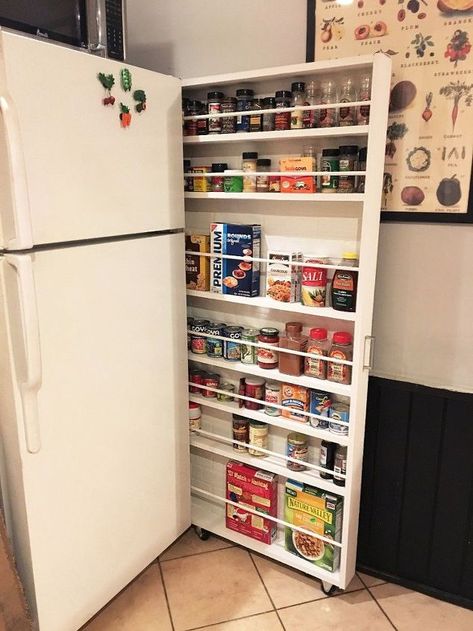 Get ready for a GAME changer! This is literally changing my life! Haha ok maybe not so dramatic, but this hide-away pantry is an amazing storage alternative that will open up some cabinet space!!! This kitchen storage is made by creating a slim sliding shelving unit for the space between your wall and refrigerator. It's amazing what a little wood and paint will do! Small Home Improvements, Food Storage Cabinet, Storage Hacks Diy, Canned Food Storage, Kitchen Storage Space, Woodworking Storage, Small Kitchen Organization, Kitchen Organization Diy, Fridge Storage