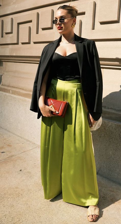 White person looking off to the side wearing a black jacket, black shirt, and green silk pants with a red hand bag. Green Silk Pants Outfit, Silk Pants Outfit Street Styles, Green Silk Pants, Silk Pants Outfit, Green Pants Outfit, Late Summer Outfits, New York Fashion Week Street Style, The Best Street Style, Summer Outfit Inspiration